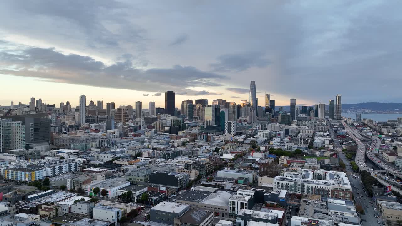 Wide angle view of San Francisco's skyline and urban landscape with sunset clouds