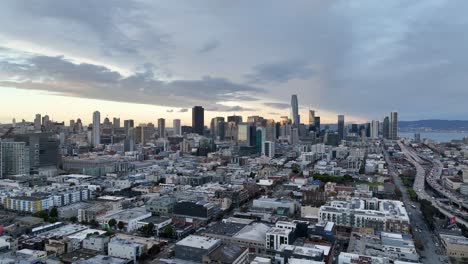 wide angle view of san francisco's skyline and urban landscape with sunset clouds