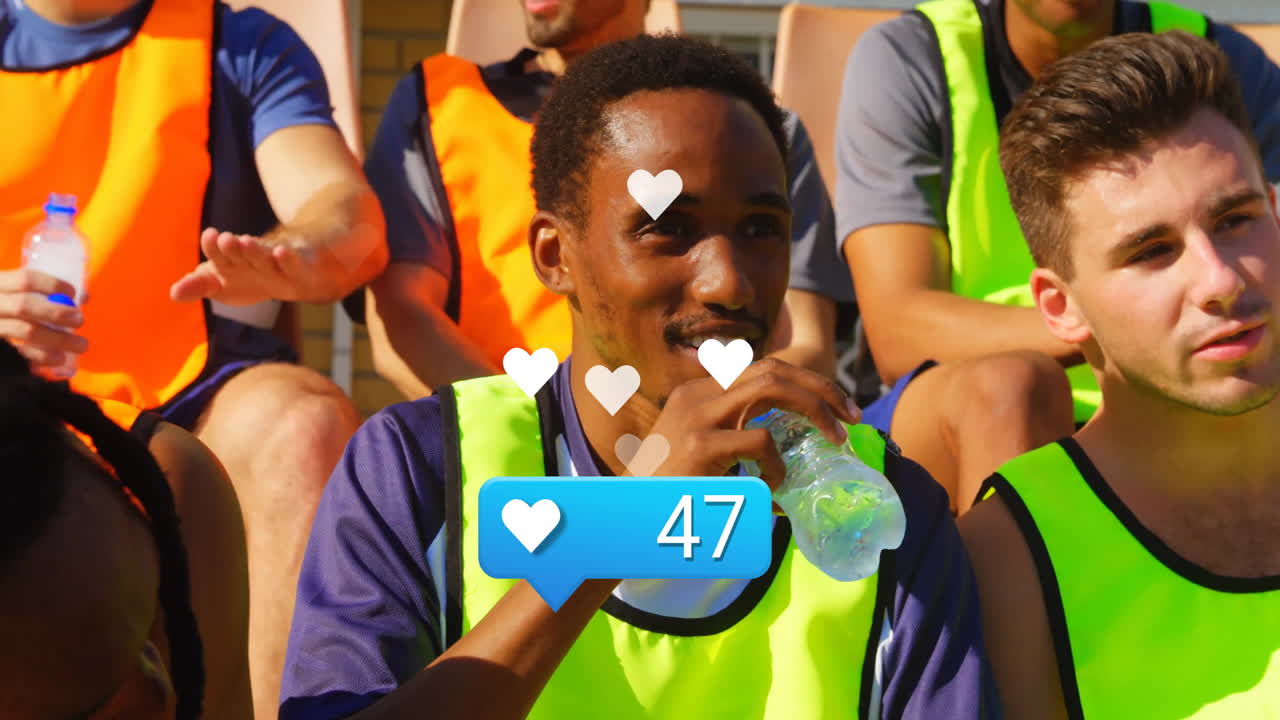 Soccer players on bench with social media likes animation overlay