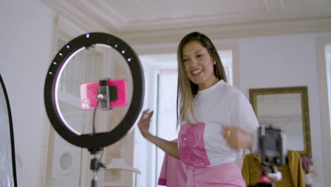 pretty long-haired caucasian woman recording video for her vlog