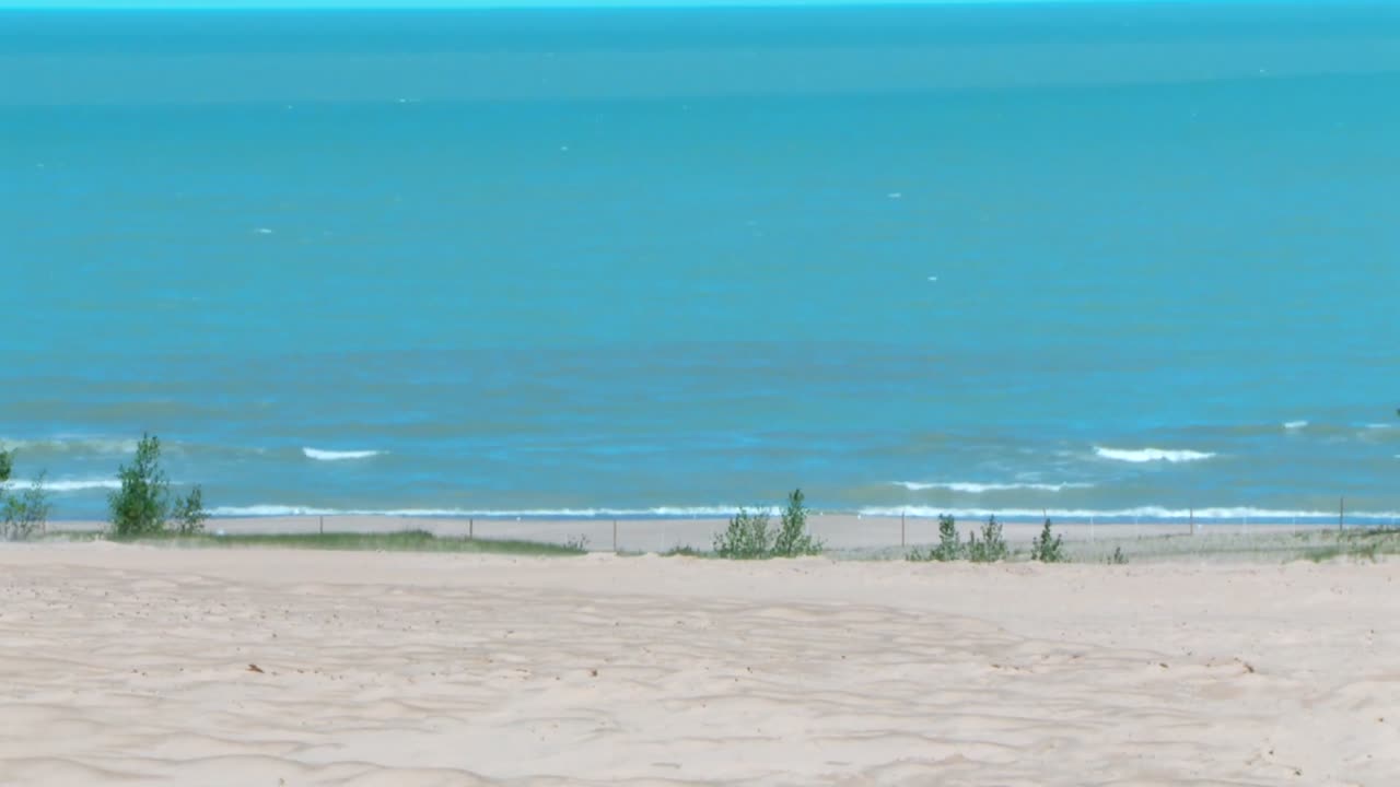 Tilt up shot from sandy beach to Lake Michigan, Indiana Dunes National Park, USA