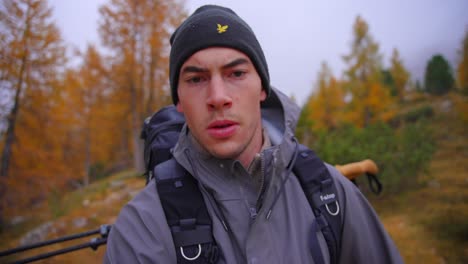 mountains and forest in alps, italian dolomites with a man running down hill filmed in cloudy and fogy weather