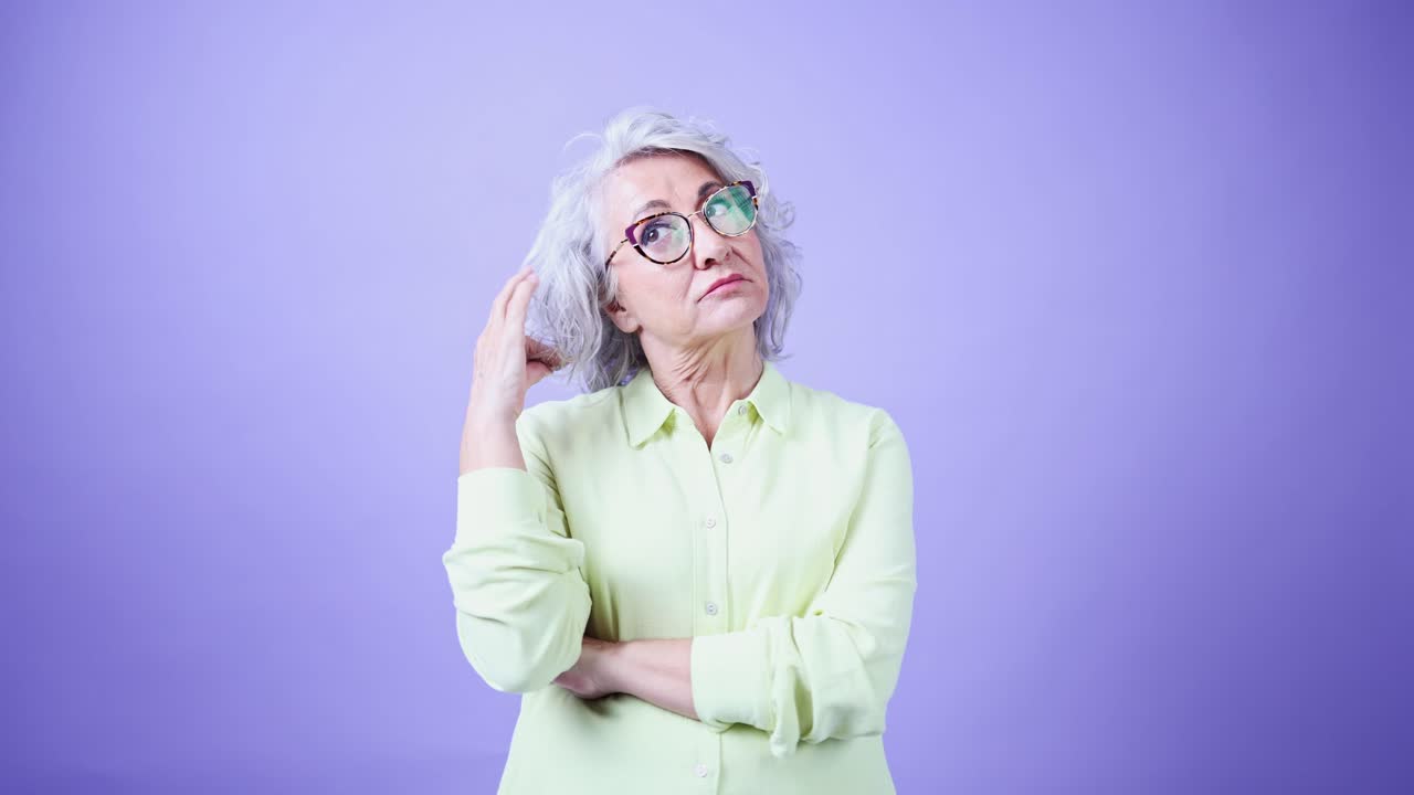 Thoughtful Senior Woman with Glasses Looking Up and Thinking