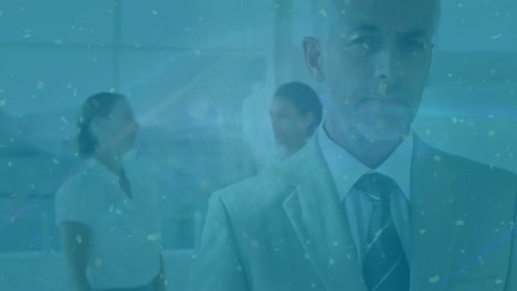 animation of golden confetti falling over caucasian businessman talking looking at the camera