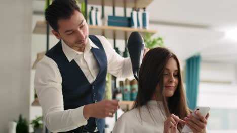 handheld view of woman enjoying wireless internet in hair salon