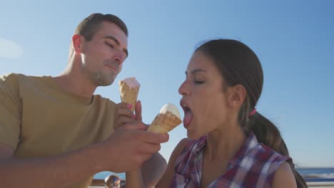 Young-adult-couple-relaxing-at-the-seaside