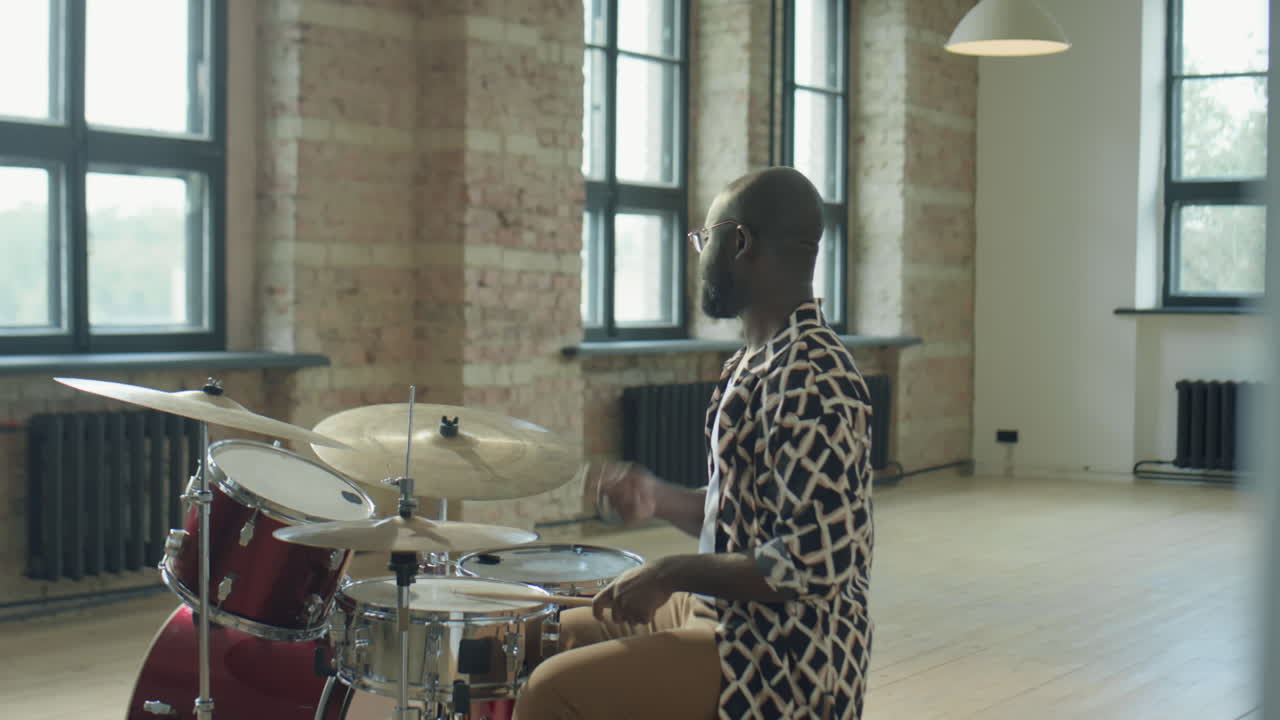 Black Drummer Playing Drums in Music Studio