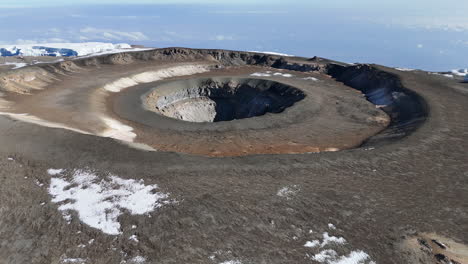 drone shot of uhuru peak on mount kilimanjaro with the volcanic crater below. slowly descending aerial shot