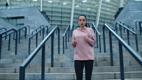 Sporty-woman-running-down-stairs-outdoor.-Runner-woman-jogging-down-stairs