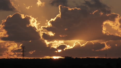 beautiful panorama shot of idyllic sunset with moving clouds in nature