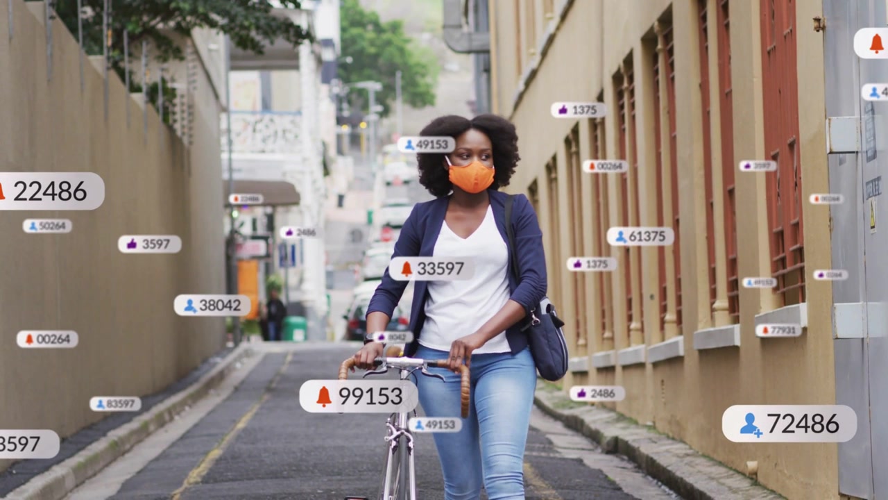 Cyclist walking bike down urban lane, movement initiating tech badges appearing and showing updates