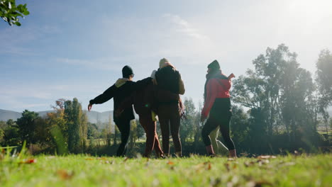 Back,-friends-jumping-and-hugging-while-camping