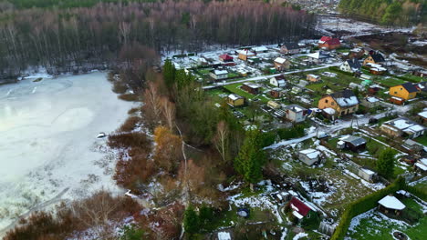 Residential-Houses-In-Rural-Village-By-The-Frozen-Lake-In-Winter