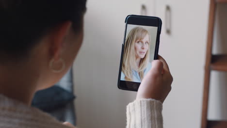 young-woman-having-video-chat-using-smartphone-at-home-chatting-to-friend-showing-off-apartment-sharing-lifestyle-enjoying-online-communication