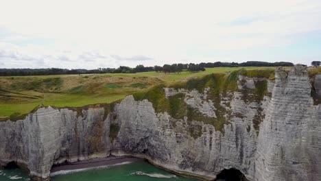 flying towards the rocky coastline of normandy, next to etretat in france