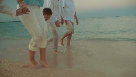 little boy running alongside the sea