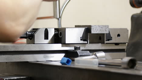 close-up of a worker operating a milling machine in a factory