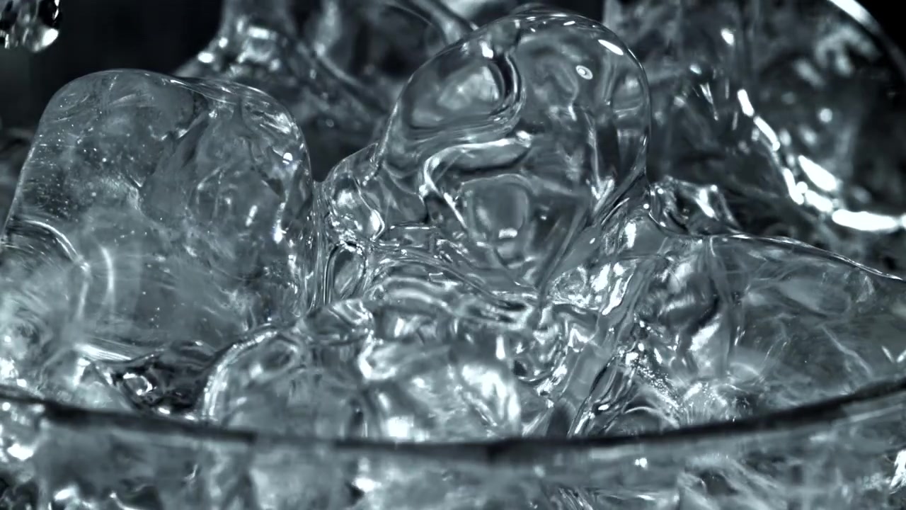 Refreshing Water Pouring Over Clear Ice Cubes in a Glass