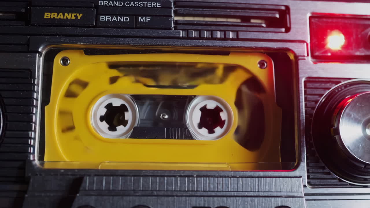 Yellow Cassette Tape Playing in a Retro Boombox