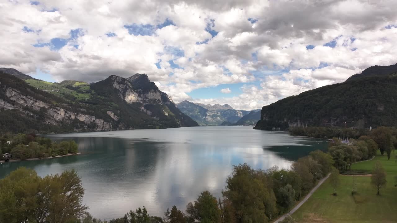 Peaceful aerial view of the stunning Walensee Lake in Switzerland, surrounded by majestic mountains and tranquil waters. Natural beauty and the calmness of the Swiss countryside.