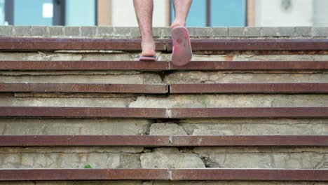 Climbing-up-the-grunge-concrete-stairs-in-flip-flops,-upwards-movement-in-life