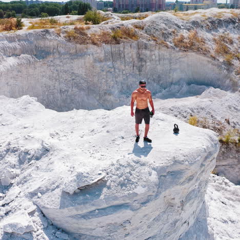 Healthy male resting and drinking water after exercising. Concept of sport outdoors.