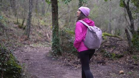 Hiker-girl,-woman-outdoors-in-mountain-forest,-nature-walking,-strolling,-wandering-at-the-woods-on-winter