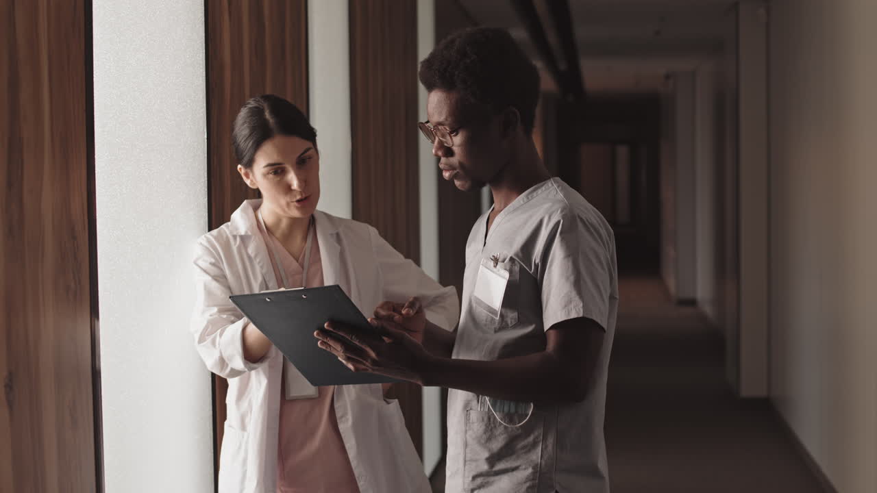 Medical Staff Discussing Patient Care in Hospital Hallway
