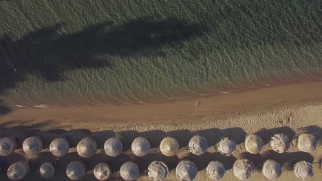 Aerial-vacation-scene-of-sea-and-beach-with-straw-umbrellas