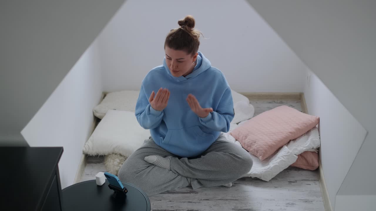 Woman having a video call while dancing at home