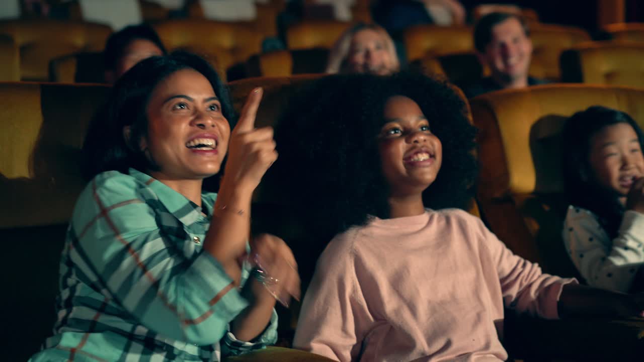 People audience watching movie in cinema theater.
