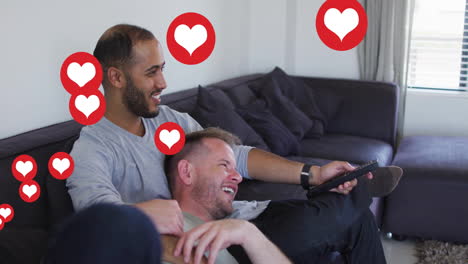 two men cuddling on couch in home entertainment scene, with floating heart icons and tv remote
