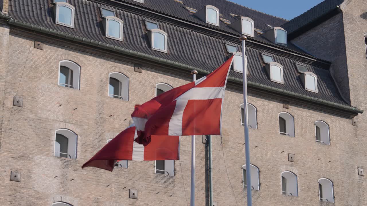 Flag of Denmark flutter in wind at Amalienborg square, Copenhagen