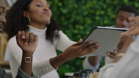 young african american engineers developing mobile software application using digital tablet computer brainstorming design solution sharing ideas collaborating in startup office meeting close up