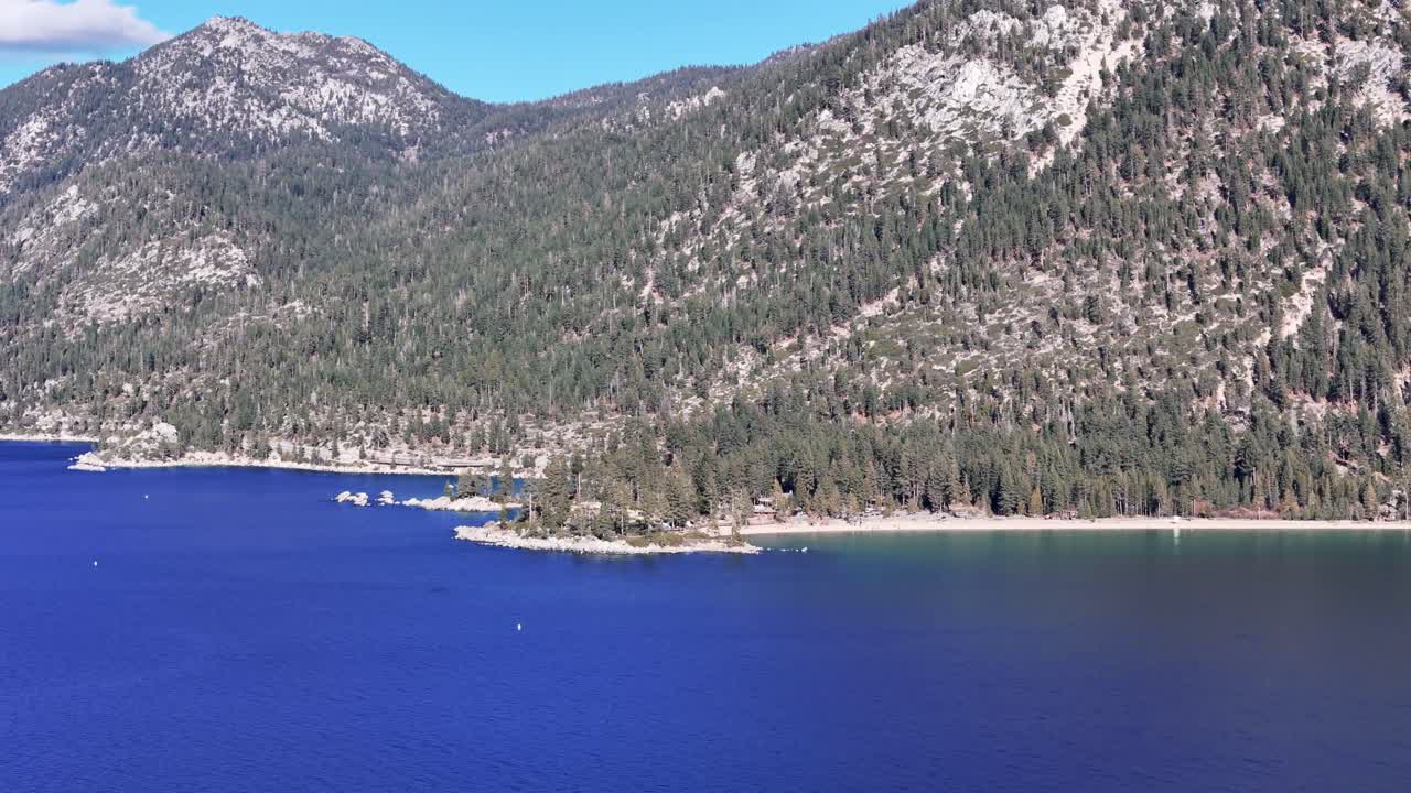 Aerial view of Sand Harbor beach and rocky coast at Lake Tahoe with steep mountains