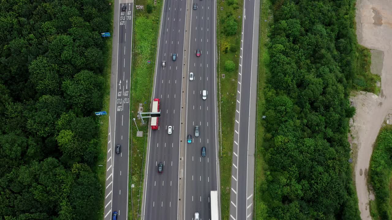 Birdseye drone aerial view following the motorway with a lift reveal to the Derbyshire countryside