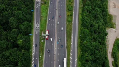 birdseye drone aerial view following the motorway with a lift reveal to the derbyshire countryside
