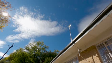 time lapse of a satelite dish with clouds in the background