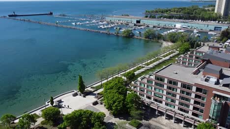 drone flying close towards a sidewalk on the lakeshore of mississauga