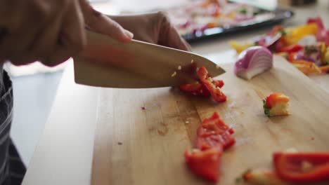 mid section of african american woman preparing dinner in kitchen