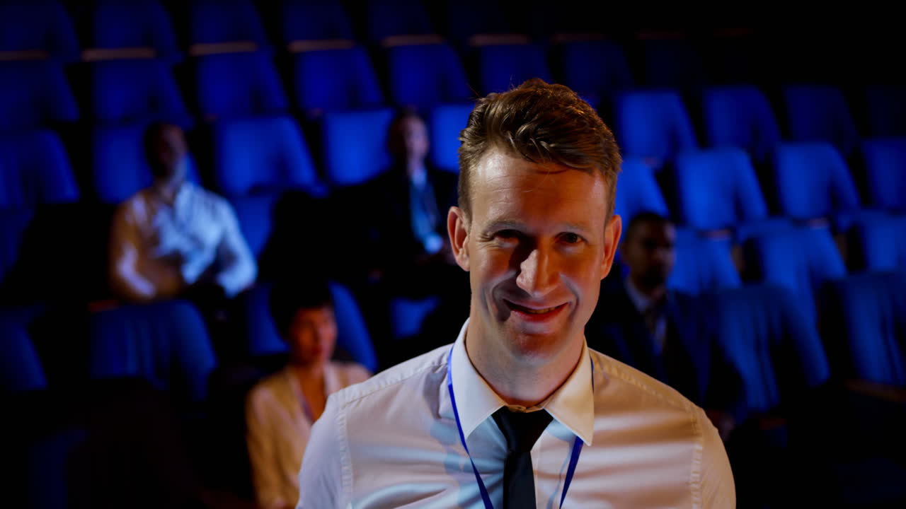 Caucasian businessman attending business seminar in auditorium 4k