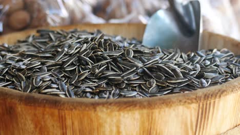 a wooden bowl filled with sunflower seeds