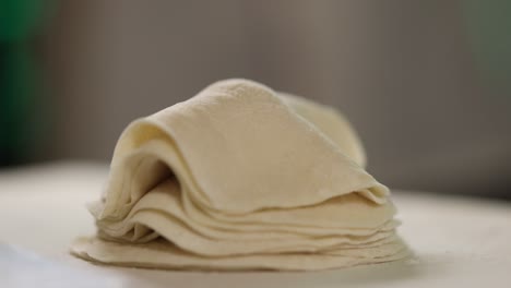 professional chef neatly stacks prepared dumpling dough