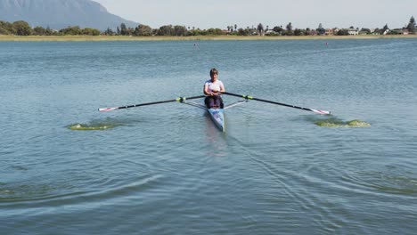 Senior-caucasian-woman-rowing-boat-on-a-river