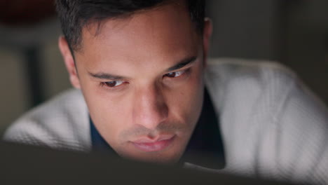 face of businessman reading email on computer