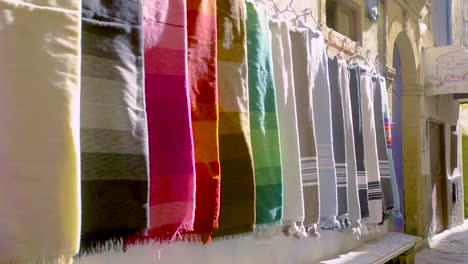 colourful fabrics hanging from wall