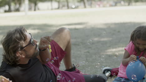 slider shot of happy family having picnic in nature