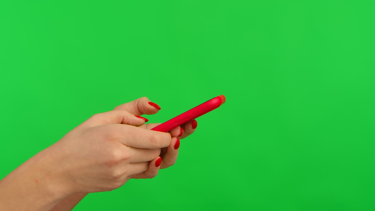 Woman using a red smartphone on green screen