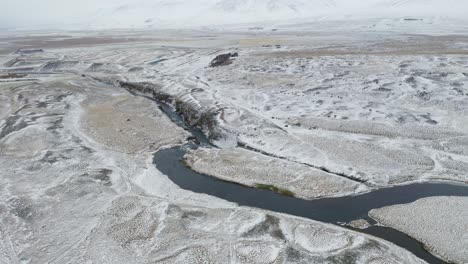 Aerial-tilt-down-shot-showing-massive-arctic-Waterfall-flowing-into-River-Delta-in-Iceland---Reykjafoss,Norðurland,-Skagafjarðarsýsla