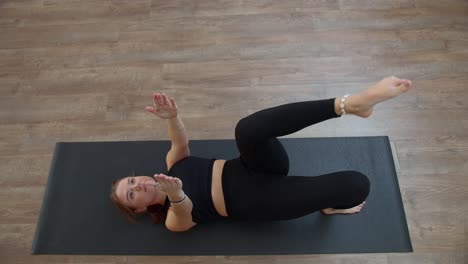 woman practicing yoga on a mat